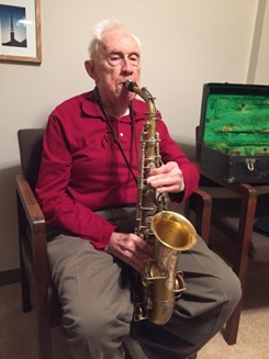 Harry Freeman playing his alto saxophone at home